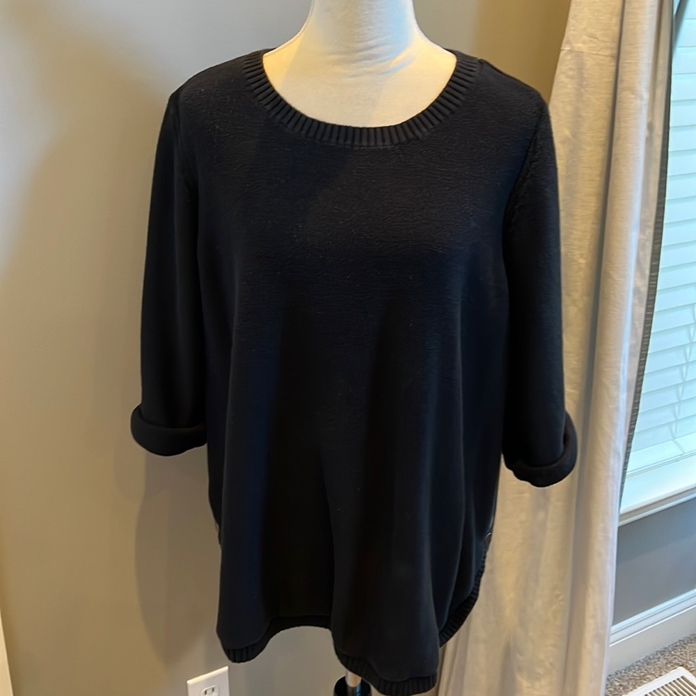 Black crewneck sweater with rolled three-quarter sleeves